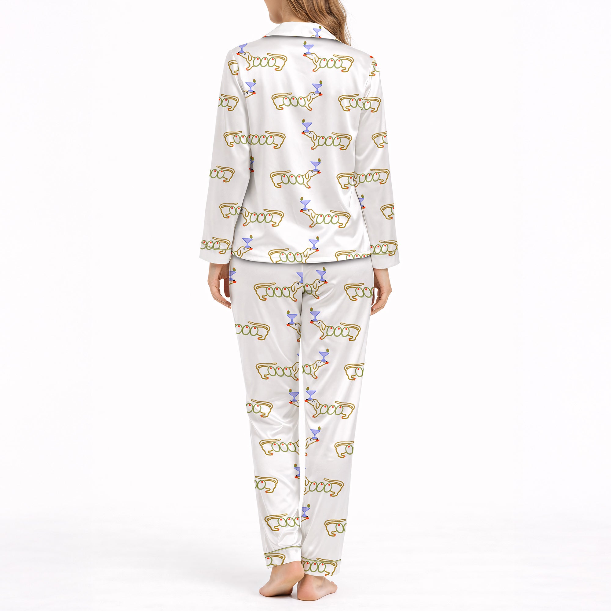 White pajama set with short sleeve button down top and shorts, featuring a playful pattern of cartoon dachshund dogs, some holding blue martini glasses, and the word 'GOOD' stylized as a dog, with green piping.