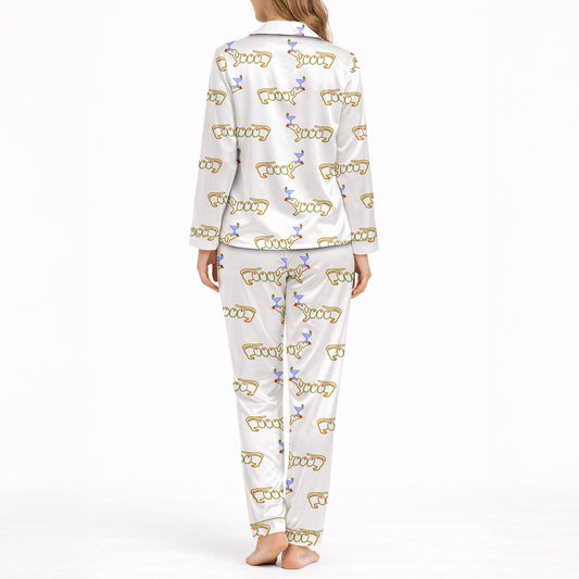 White pajama set with short sleeve button down top and shorts, featuring a playful pattern of cartoon dachshund dogs, some holding blue martini glasses, and the word 'GOOD' stylized as a dog, with green piping.