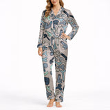 Women's pajama set with an all-over playful cartoon penis pattern in blue, grey, and teal colors on a light background, featuring a short-sleeve button-down top and matching shorts.