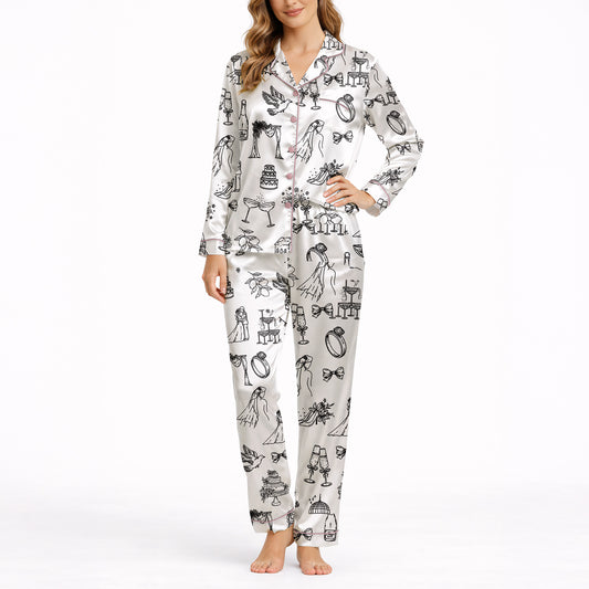 Women's pajama set featuring a black and white hand-drawn wedding doodle pattern with brides, grooms, cakes, rings, and champagne glasses on a white background, perfect for bridal loungewear.