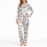 Women's pajama set featuring a black and white hand-drawn wedding doodle pattern with brides, grooms, cakes, rings, and champagne glasses on a white background, perfect for bridal loungewear.