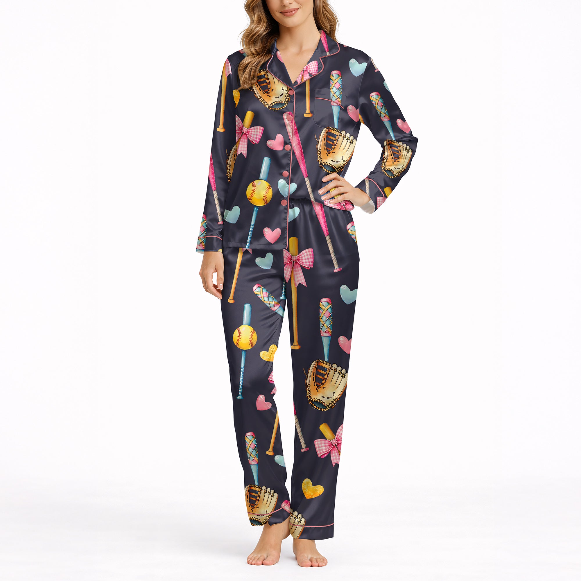 Women's navy blue pajama set with a cute softball and baseball pattern featuring bats, gloves, softballs, hearts, and bows, made from soft knit fabric.