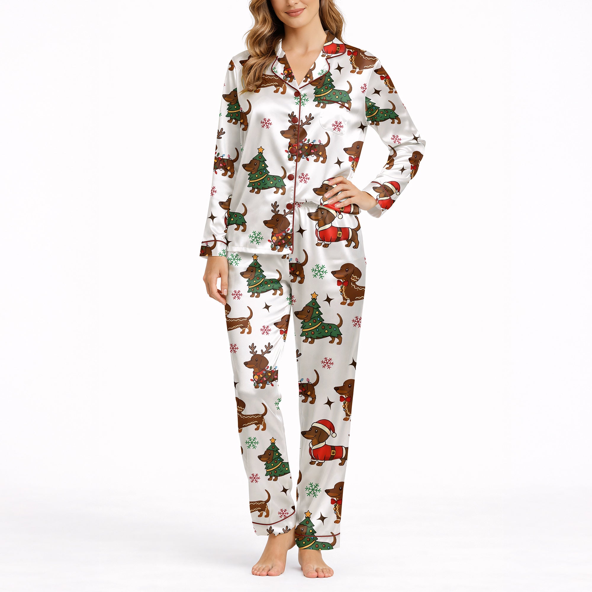 A woman wearing a white short sleeve pajama set with shorts, featuring a festive Christmas pattern of cartoon dachshunds dressed as Santa, reindeer, and Christmas trees. The pajamas have red piping.
