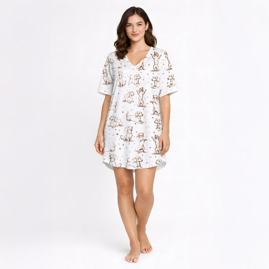 Women's cream pajama set with short sleeves and shorts, featuring a playful sepia-toned Dachshund dog print and small star accents.