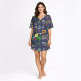 Women's pajama set with a vibrant Caribbean-themed pattern featuring Coquí frogs, Salsa hearts, Puerto Rico flag, coffee and rum drinks, palm trees, and cameras on a dark blue background.