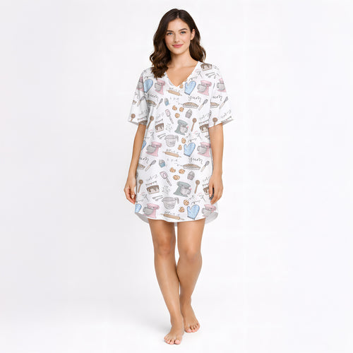 Women's baking-themed pajama set featuring cute illustrations of stand mixers, cupcakes, cookies, and baking tools in pastel colors on a white background.