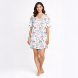 Women's baking-themed pajama set featuring cute illustrations of stand mixers, cupcakes, cookies, and baking tools in pastel colors on a white background.