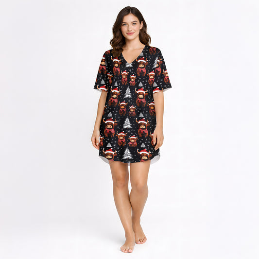 Women's Christmas pajama set featuring a festive pattern of cute Highland cows wearing Santa hats and plaid scarves, with white Christmas trees and snowflakes on a black background. The set includes a short-sleeve button-down top and matching shorts.