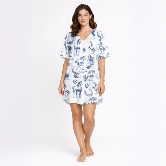 Women's pajama set with a blue sketch-style pattern of horses, horseshoes, and saddles on a white background, made from soft knit fabric.