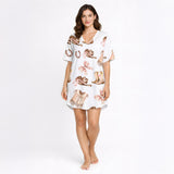 Women's pajama set featuring a charming Western-themed watercolor pattern with cowboy boots, hats, vests, horseshoes, and pink plaid bows on a white background.