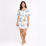 Women's white pajama set featuring a charming blue and white watercolor bunny and Easter egg pattern, with rabbits, delicate floral elements, and vintage-style carts, perfect for spring sleepwear.