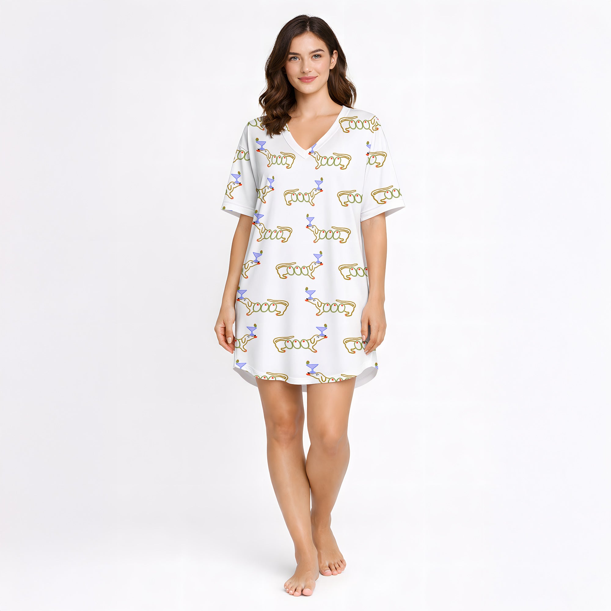 White pajama set with short sleeve button down top and shorts, featuring a playful pattern of cartoon dachshund dogs, some holding blue martini glasses, and the word 'GOOD' stylized as a dog, with green piping.