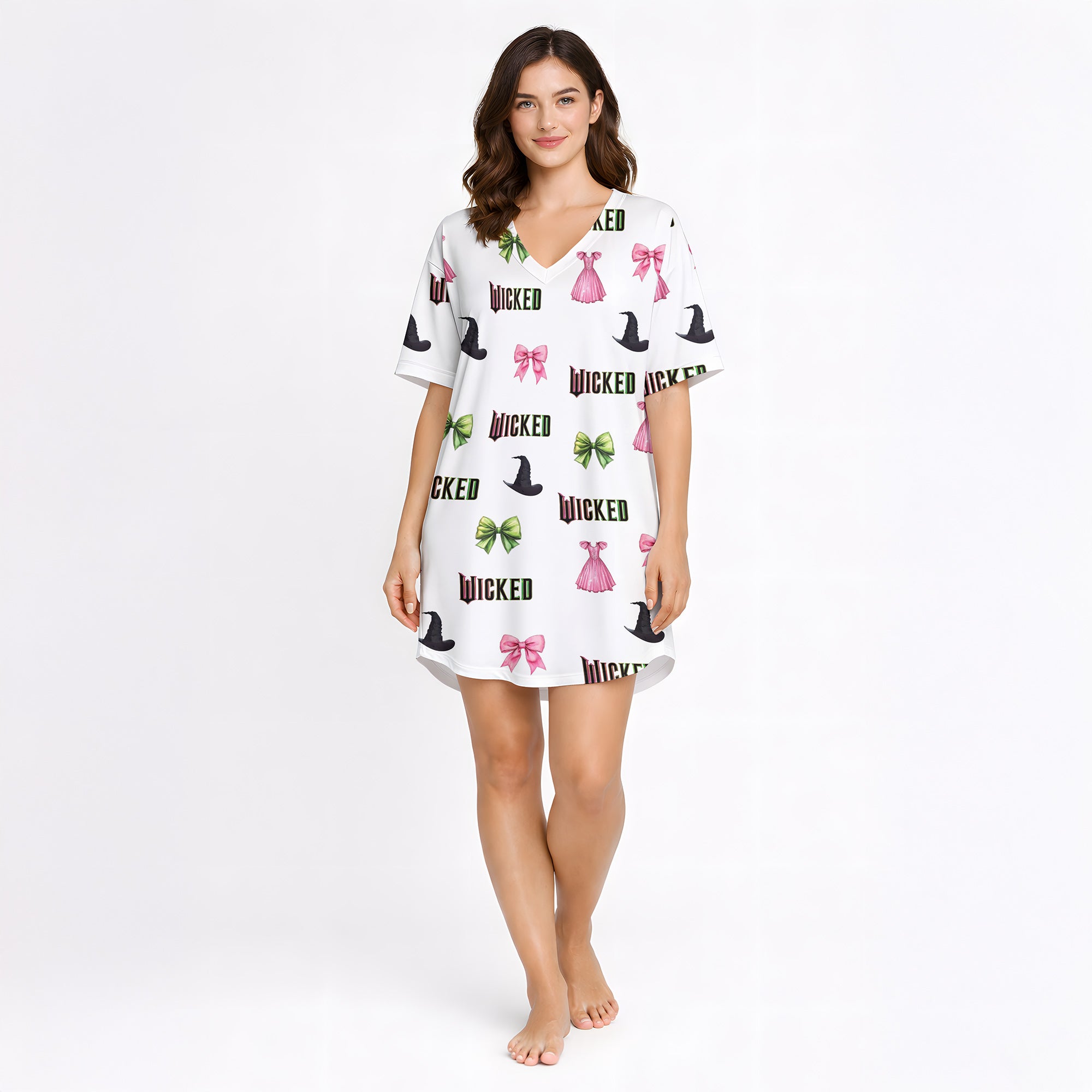 Women's pajama set featuring a 'Wicked' themed pattern with witch hats, pink bows, green bows, and pink dresses on a light background, made from soft knit fabric.