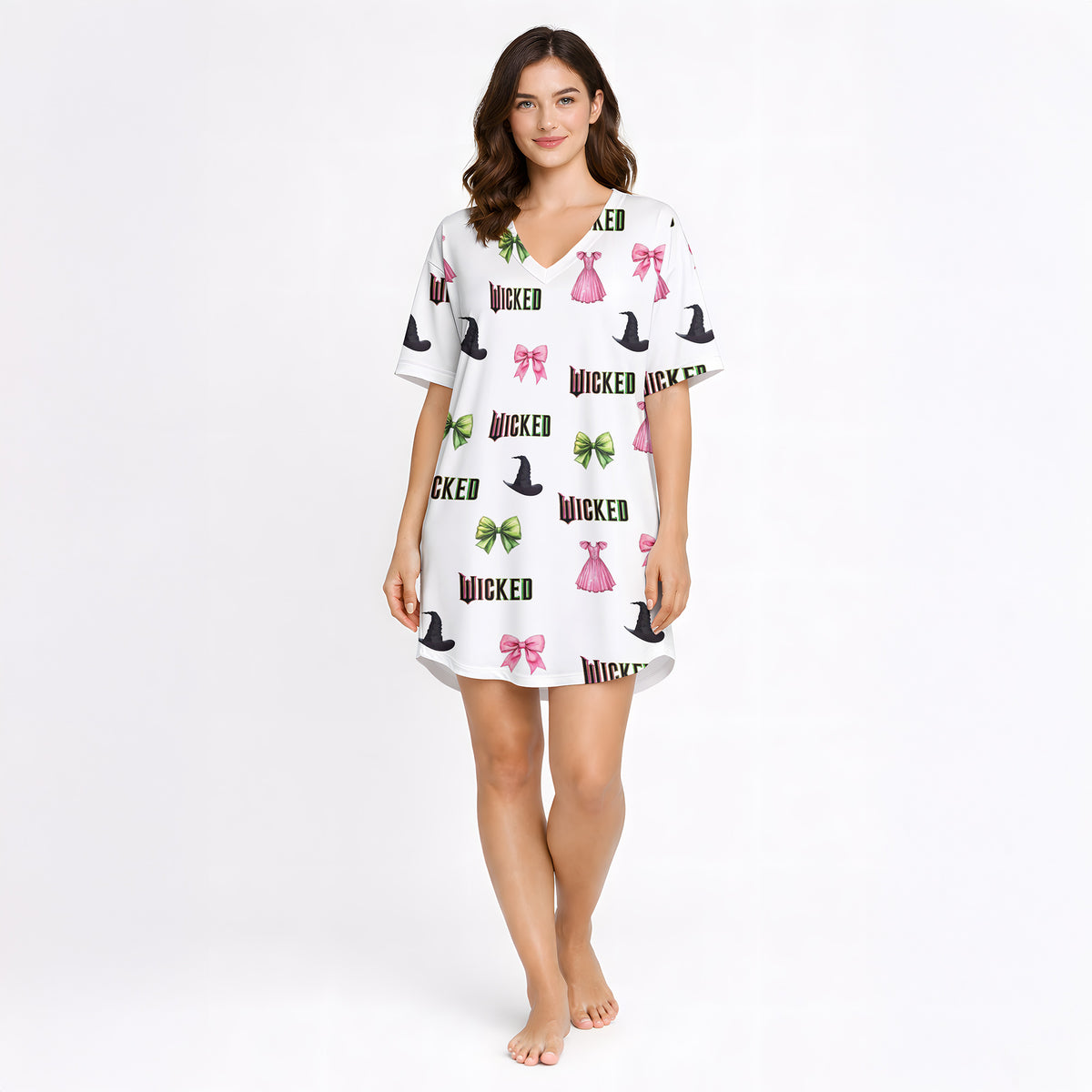 Women's pajama set featuring a 'Wicked' themed pattern with witch hats, pink bows, green bows, and pink dresses on a light background, made from soft knit fabric.