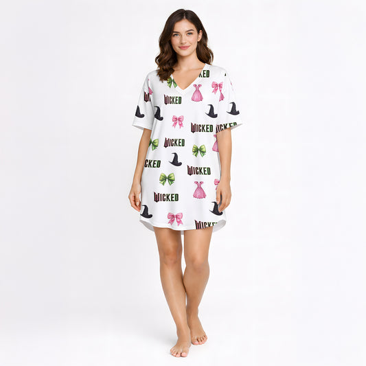 Women's pajama set featuring a 'Wicked' themed pattern with witch hats, pink bows, green bows, and pink dresses on a light background, made from soft knit fabric.