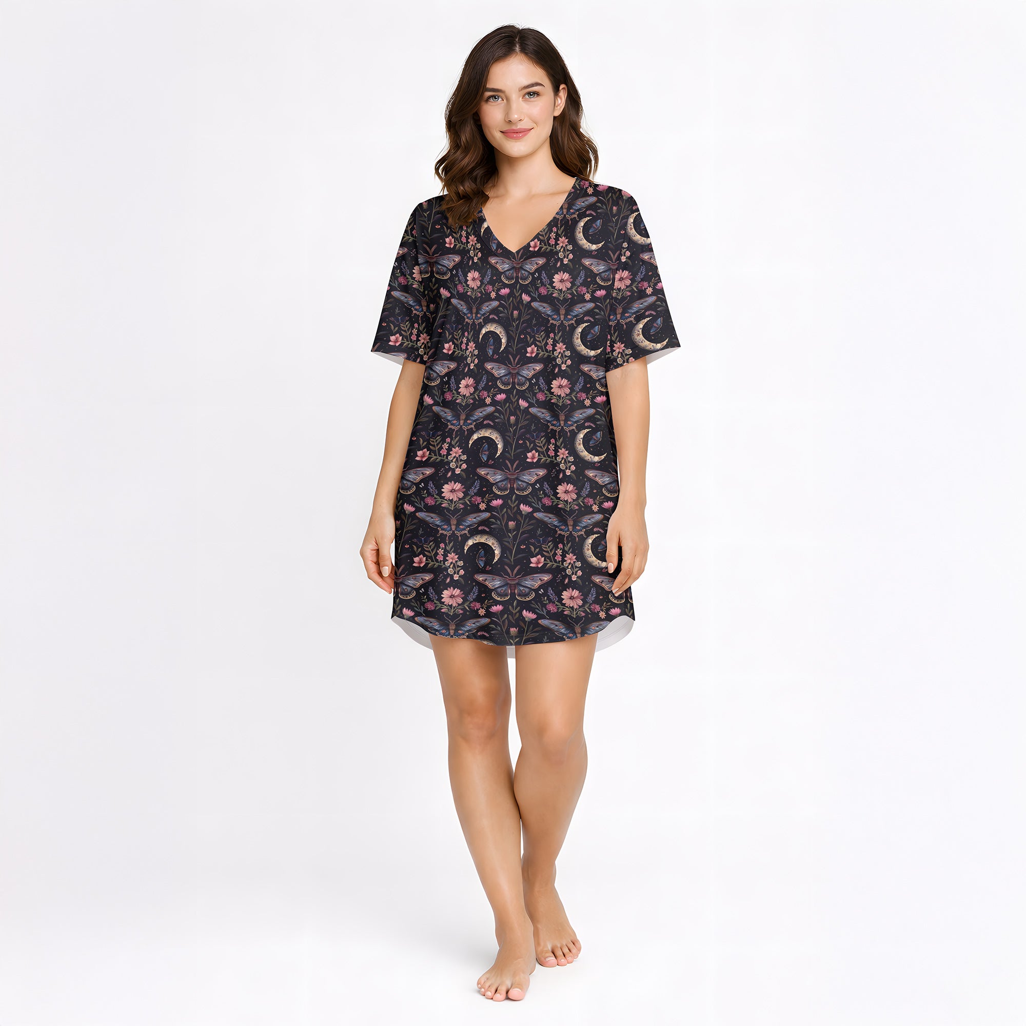 Women's short sleeve button down pajama set with shorts featuring a dark celestial and botanical print of moths, crescent moons, and pink flowers on a black background.
