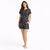 Women's pajama set featuring a vibrant, psychedelic mushroom and star pattern on a black background, showcasing colorful fungi in various shapes and sizes.