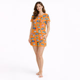 Women's orange pajama set with a playful sardine and sardine can print, made from soft knit fabric.