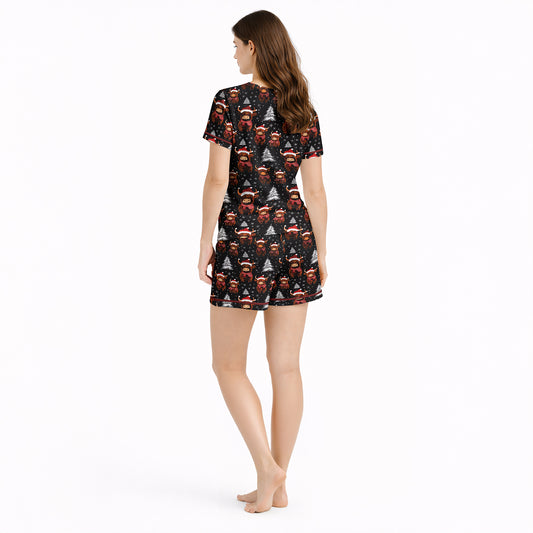 Women's Christmas pajama set featuring a festive pattern of cute Highland cows wearing Santa hats and plaid scarves, with white Christmas trees and snowflakes on a black background. The set includes a short-sleeve button-down top and matching shorts.