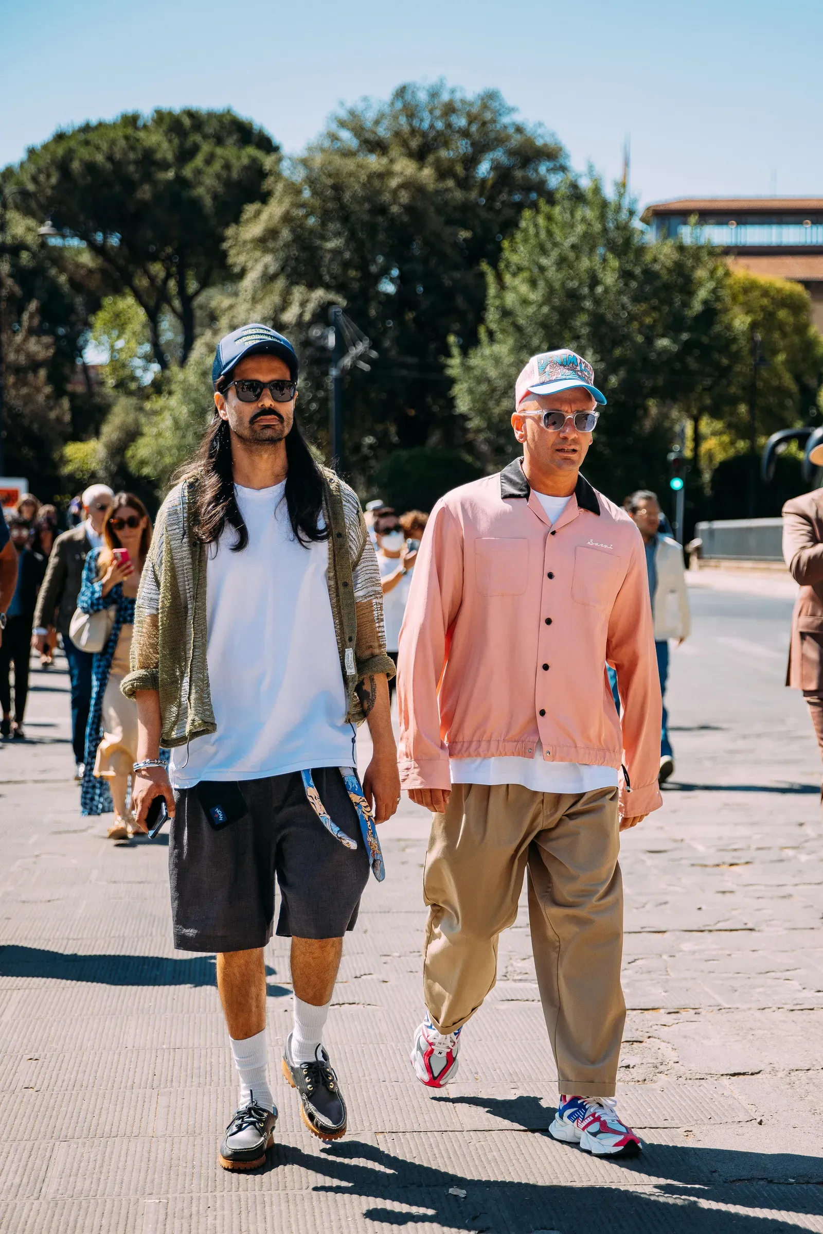 Pairing outfits with oversized T shirt, cargo shorts, and trucker hat