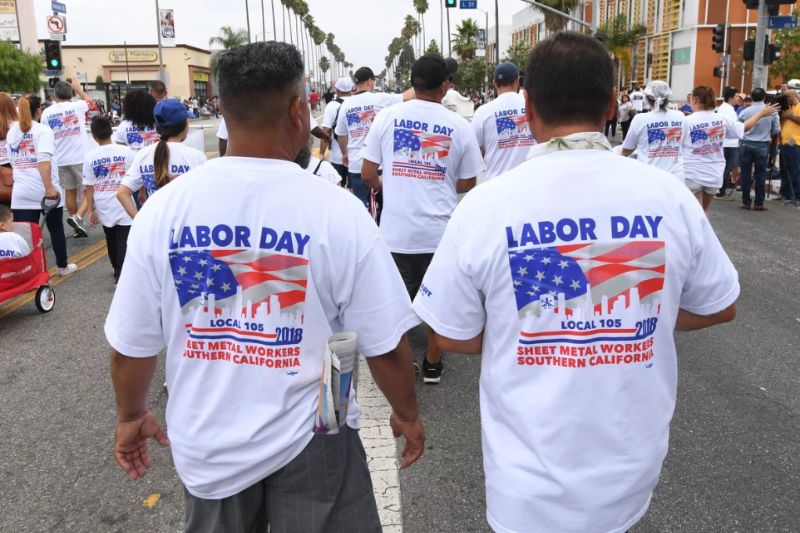 Union members and their families march in the annual Labor Day parade in Long Beach, Calif